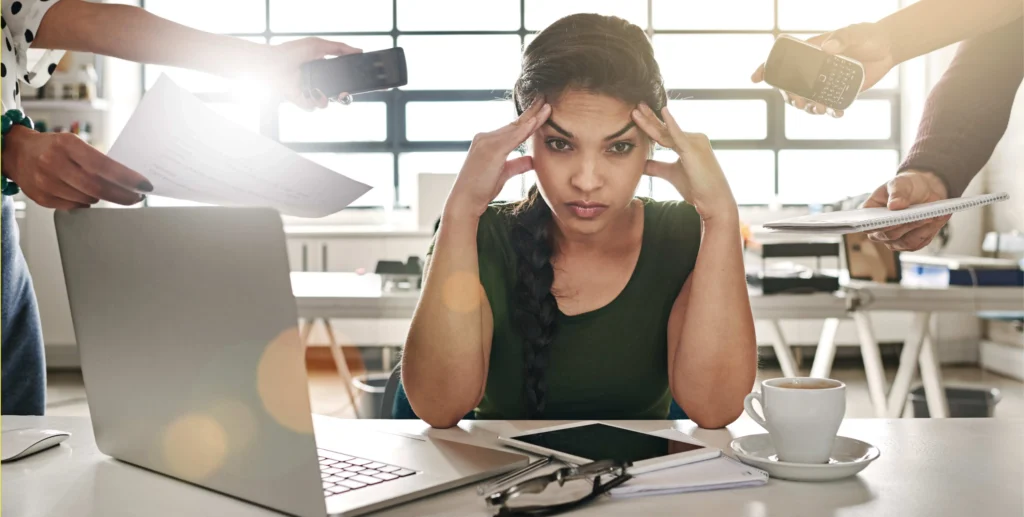 Woman in an office environment suffering from cognitive overload